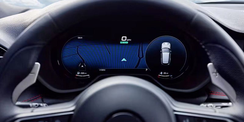 A car's digital dashboard display shows "READY," 0 mph, a map with current location, and a top-down view of the car