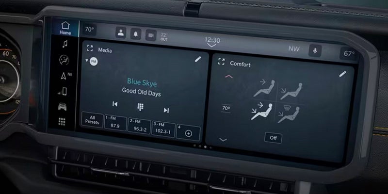 A car's dashboard infotainment system displaying "Blue Skye, Good Old Days" music and climate control with seat warmers.